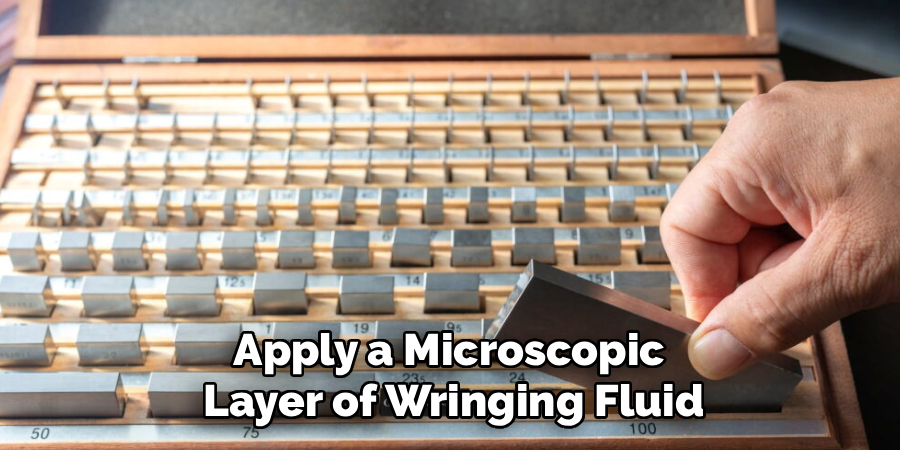 Apply a Microscopic
Layer of Wringing Fluid