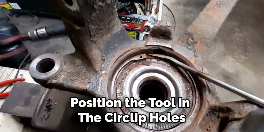 Position the Tool in
The Circlip Holes