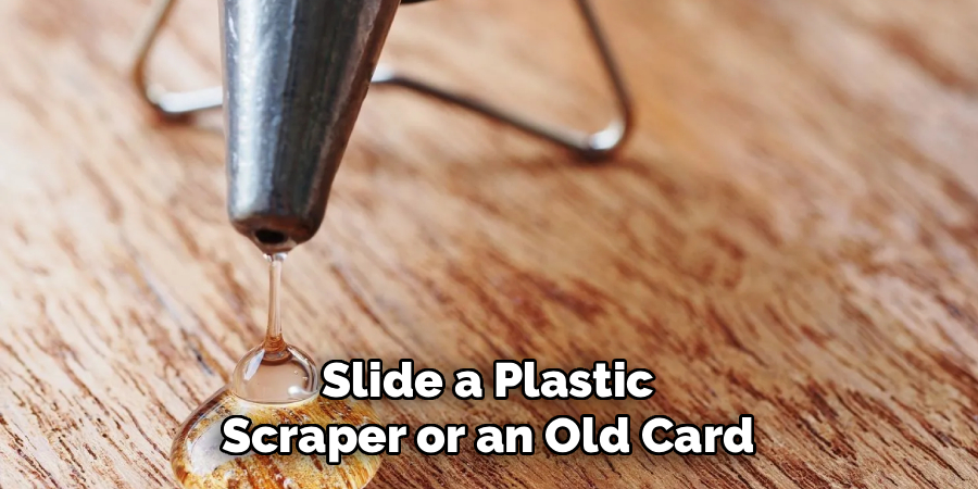 Slide a Plastic
Scraper or an Old Card