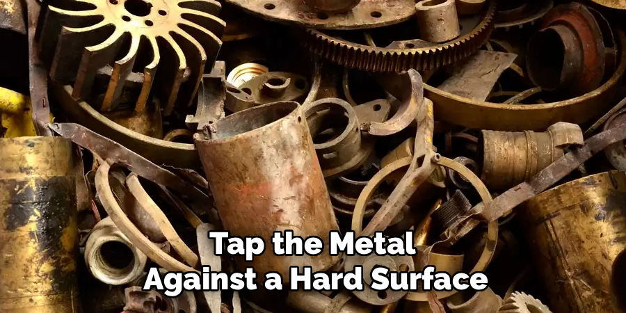 Tap the Metal 
Against a Hard Surface